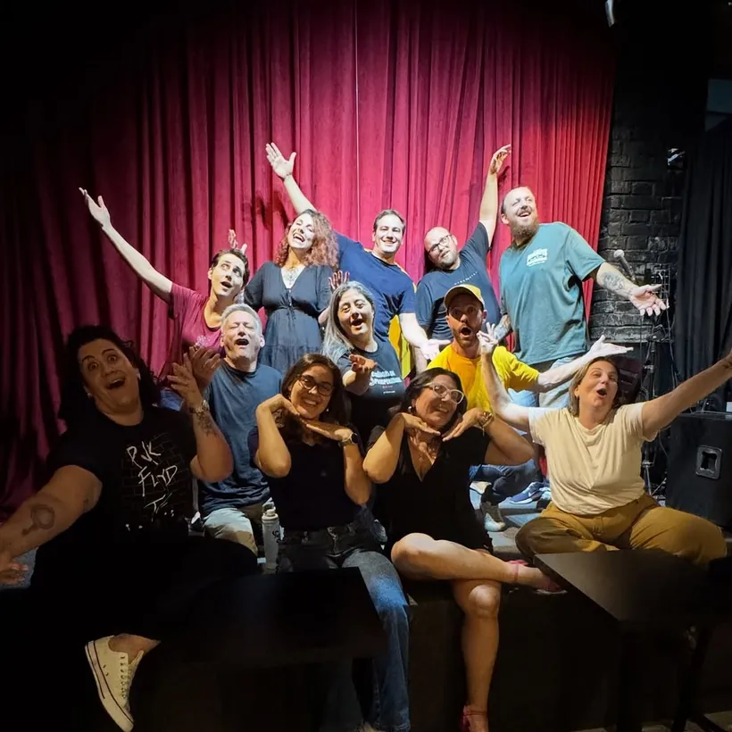 Turma do Nível 2 no palco, de braços para o alto
